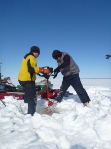 Chris Arp (left) and Ben Jones (right) drill into the ice of a shallow lake on Alaska's North Slope. Credit: Guido Grosse, Alfred Wegener Institute.