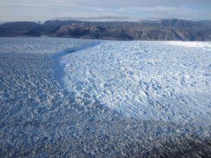 The marine terminus of Helheim Glacier and the matrix of calved icebergs and sea ice, called ice mélange, in Sermilik Fjord, Greenland, from July 2014. Credit: Ellyn Enderlin 