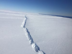 Rift in Pine Island Glacier ice shelf, West Antarctica, photographed from the air during a NASA Operation IceBridge survey flight on November 4, 2016. This rift is the second to form in the center of the ice shelf in the past three years. The first resulted in an iceberg that broke off in 2015. Credit NASA/Nathan Kurtz. 