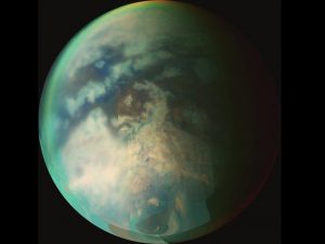 New research provides evidence of rainfall on the north pole of Titan, the largest of Saturn’s moons, shown here. The rainfall would be the first indication of the start of a summer season in the moon’s northern hemisphere, according to the researchers. Credit: NASA/JPL/University of Arizona