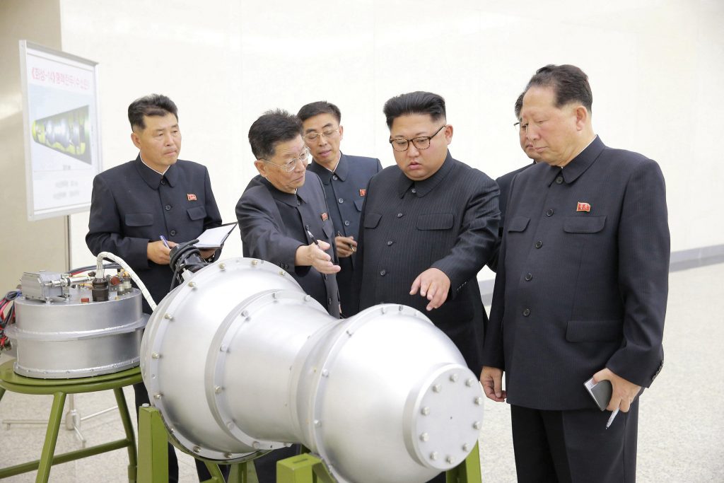 North Korean leader Kim Jong-un points to a device with the characteristic two-hemisphere peanut shape of a fusion bomb in an image released by North Korean state media in 2017. Officials in Pyonyang said the object was a hydrogen bomb. Credit: Korean Central News Agency