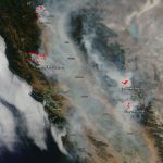 A satellite image, August 6, 2018, shows smoke from multiple large California wildfires. The fires themselves, detected by thermal imagery, are in red. Credit: NASA.
