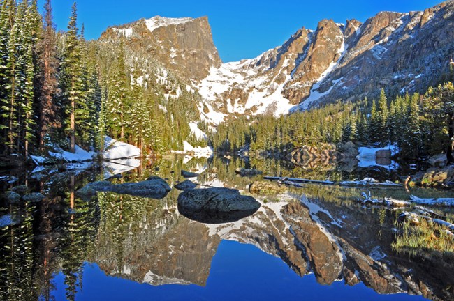 A view of Hallett Peak and Dream Lake in the Rocky Mountains of the American West. New research finds consecutive low snow years may become six times more common across the Western United States over the latter half of this century. Credit: National Parks Service. 