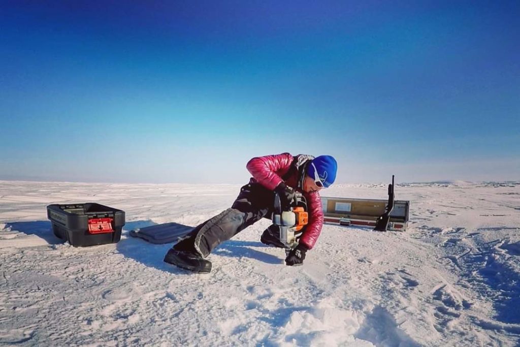 Alison Criscitiello, a glaciologist at the Canadian Ice Core Laboratory at the University of Alberta and an author of the new study, drills an ice core from the Devon Ice Cap, Nunavut, in the Canadian Arctic. Credit: Anja Rutishauser