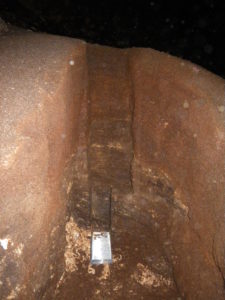 photograph of a verticle cut-away of a 2-meter pile of bat guano