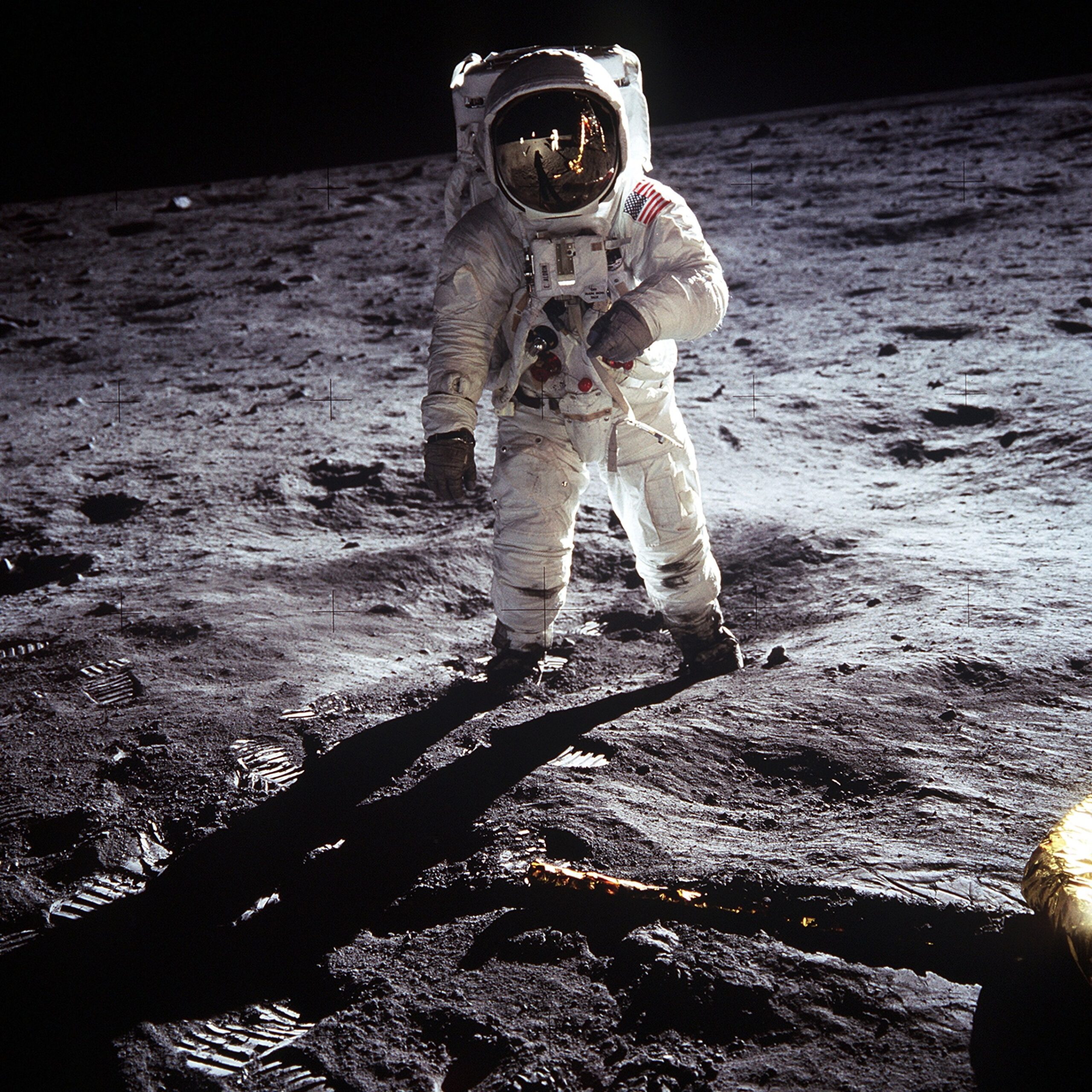 An astronaut stands on the Moon.
