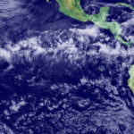 A view of Earth from space showing parts of Central and South America. A band of clouds wraps around the equator.