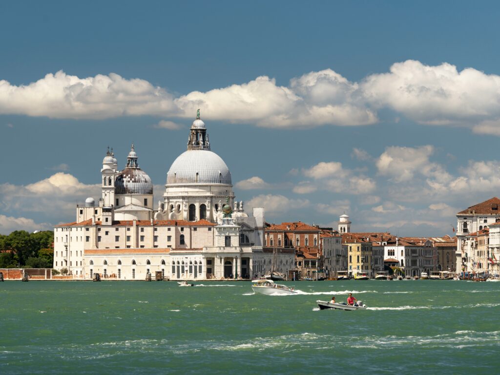 A waterway with several boats in the city of Venice, Italy. 